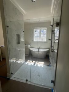 Frameless glass shower enclosure with a freestanding tub in a Mobile, AL bathroom